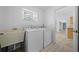 Functional laundry room with a sink, washer, and dryer, offering convenience at 11645 Sw 75Th Cir, Ocala, FL 34476