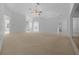 Large living room with neutral carpet, ceiling fan, and an open, airy feel at 11645 Sw 75Th Cir, Ocala, FL 34476