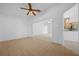 Open-concept living room showcasing tile floors that lead to the kitchen and carpeted den at 11645 Sw 75Th Cir, Ocala, FL 34476