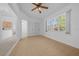 Sun-drenched living room featuring tile flooring, a ceiling fan, and backyard views through a large window at 11645 Sw 75Th Cir, Ocala, FL 34476