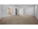 Large carpeted main bedroom with ensuite bathroom and walk-in closet entrances providing flexible room design at 11645 Sw 75Th Cir, Ocala, FL 34476