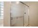 Shower with glass doors and block window providing natural light and privacy in the bathroom at 11645 Sw 75Th Cir, Ocala, FL 34476