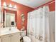 Stylish bathroom with seahorse decor, seashell shower curtain, toilet, and modern vanity at 11828 Se 91St Cir, Summerfield, FL 34491