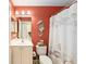 Stylish bathroom with seahorse decor, seashell shower curtain, toilet, and modern vanity at 11828 Se 91St Cir, Summerfield, FL 34491