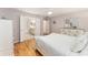 Well-lit bedroom features hardwood floors, a ceiling fan, ensuite access, and a neutral paint scheme at 11828 Se 91St Cir, Summerfield, FL 34491
