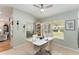 Charming dining area with a white table set, surrounded by windows offering natural light and views at 11828 Se 91St Cir, Summerfield, FL 34491