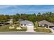 Exterior view of a well-manicured home with lush landscaping and a charming front yard, perfect for outdoor enjoyment at 11828 Se 91St Cir, Summerfield, FL 34491