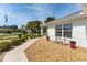 Close-up of a meticulously landscaped front yard with a cozy seating area and charming decorative touches at 11828 Se 91St Cir, Summerfield, FL 34491