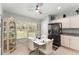 Bright kitchen dining area featuring a white table set, large windows, and modern cabinets at 11828 Se 91St Cir, Summerfield, FL 34491
