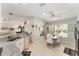 Spacious kitchen with granite counters, black appliances, and a view into the living room and dining area at 11828 Se 91St Cir, Summerfield, FL 34491