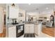 Well-appointed kitchen with granite countertops, black appliances, and seamless connection to the living room at 11828 Se 91St Cir, Summerfield, FL 34491