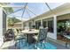 Outdoor living space with dining table and seating for entertaining or enjoying a meal outdoors at 11828 Se 91St Cir, Summerfield, FL 34491