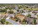 Aerial view showcasing the home's location within a quiet neighborhood and a golf course nearby at 13109 Se 86Th Ct, Summerfield, FL 34491