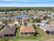 Aerial view of neighborhood featuring a pond and well-maintained landscaping at 13109 Se 86Th Ct, Summerfield, FL 34491