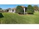 Exterior view of the home featuring well-manicured lawn and screen enclosed lanai at 13109 Se 86Th Ct, Summerfield, FL 34491