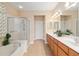 Bathroom showcasing double vanity, separate shower, and soaking tub at 13109 Se 86Th Ct, Summerfield, FL 34491