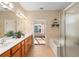 Bathroom featuring a double vanity, walk-in shower, and soaking tub at 13109 Se 86Th Ct, Summerfield, FL 34491