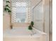 Bathroom featuring soaking tub, glass shower door, and window with chevron valance at 13109 Se 86Th Ct, Summerfield, FL 34491