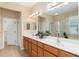 Bathroom showcasing double vanity, and a shower with glass enclosure at 13109 Se 86Th Ct, Summerfield, FL 34491