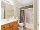 Bathroom featuring vanity, toilet, and bathtub with dark grey shower curtain at 13109 Se 86Th Ct, Summerfield, FL 34491