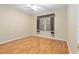 Bedroom with ceiling fan, wood floors, and window with textured curtains at 13109 Se 86Th Ct, Summerfield, FL 34491