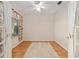 Cozy bedroom with wood floors, ceiling fan, and window with patterned curtains at 13109 Se 86Th Ct, Summerfield, FL 34491