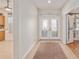 Inviting foyer with tile flooring, neutral walls, and a view of the front doors at 13109 Se 86Th Ct, Summerfield, FL 34491