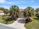 Attractive single-story home featuring mature palm trees and a paved driveway at 13109 Se 86Th Ct, Summerfield, FL 34491