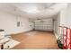 Clean garage featuring concrete flooring, overhead lighting and white brick walls at 13109 Se 86Th Ct, Summerfield, FL 34491