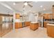 Open kitchen with island, stainless appliances, eat-in area, and view to sunroom at 13109 Se 86Th Ct, Summerfield, FL 34491