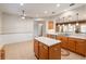 Spacious kitchen featuring an island, bar, and tile floors at 13109 Se 86Th Ct, Summerfield, FL 34491