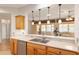 Bright kitchen with breakfast bar offering views to the adjacent sunroom at 13109 Se 86Th Ct, Summerfield, FL 34491