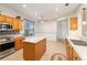 Bright kitchen features an island, stainless steel appliances and tiled floors at 13109 Se 86Th Ct, Summerfield, FL 34491