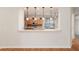 Breakfast bar with pendant lights with a partial view of the adjacent kitchen at 13109 Se 86Th Ct, Summerfield, FL 34491
