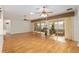 Bright living room with hardwood floors, ceiling fans, and lanai access at 13109 Se 86Th Ct, Summerfield, FL 34491