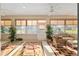 Bright sunroom featuring wicker furniture, large windows, and neutral tones at 13109 Se 86Th Ct, Summerfield, FL 34491