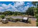 Aerial view of a single-story home with a fenced backyard and lush surroundings at 13300 Ne 38Th Ave, Anthony, FL 32617