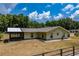 Back exterior view of a single-story home with a screened-in porch and fenced yard at 13300 Ne 38Th Ave, Anthony, FL 32617
