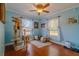Bedroom with blue walls, wood floors, and windows at 13300 Ne 38Th Ave, Anthony, FL 32617