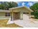 Close-up of the house featuring a stone entryway and attached garage at 13300 Ne 38Th Ave, Anthony, FL 32617
