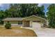 Charming single-story home with stone accents, a well-maintained lawn, and attached garage at 13300 Ne 38Th Ave, Anthony, FL 32617