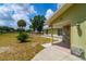 Partial front exterior view featuring partial stone facade, landscaping, and expansive yard at 13300 Ne 38Th Ave, Anthony, FL 32617
