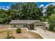Charming single-story home with a stone accent exterior, front porch, and attached garage at 13300 Ne 38Th Ave, Anthony, FL 32617