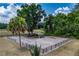 Aerial view of horse paddock featuring wood fencing, shaded shelter and mature trees at 13300 Ne 38Th Ave, Anthony, FL 32617