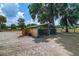 Horse stall with metal bars and wood construction surrounded by sandy paddock at 13300 Ne 38Th Ave, Anthony, FL 32617