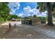 Horse stall with metal bars and wood construction surrounded by sandy paddock with horses at 13300 Ne 38Th Ave, Anthony, FL 32617