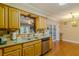 Charming kitchen featuring granite countertops, stone backsplash, and wood cabinets at 13300 Ne 38Th Ave, Anthony, FL 32617