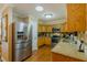 Updated kitchen featuring stainless steel appliances, wood cabinets, and granite countertops at 13300 Ne 38Th Ave, Anthony, FL 32617