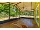 Screened lanai with tile flooring, ceiling fan, and view of the property at 13300 Ne 38Th Ave, Anthony, FL 32617