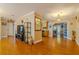 Open floor plan from living room to kitchen and dining room with wood floors at 13300 Ne 38Th Ave, Anthony, FL 32617